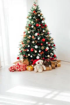 Christmas tree by the window with gift decor for the new year interior of the Stock Photos