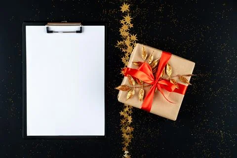 Christmas wish list with empty space for text on black background with gold.. Stock Photos