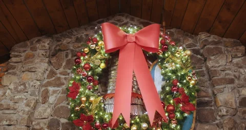 Christmas wreath with red bow on rustic stone wall Stock Footage 292306830