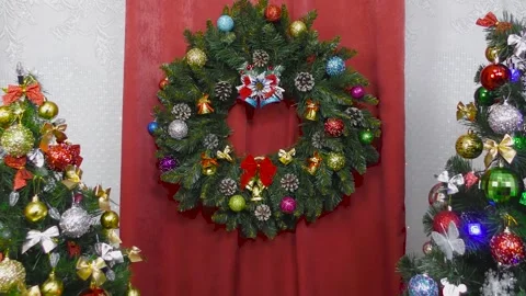 A Christmas wreath weighs between two decorated Christmas trees Stock Footage 146720428