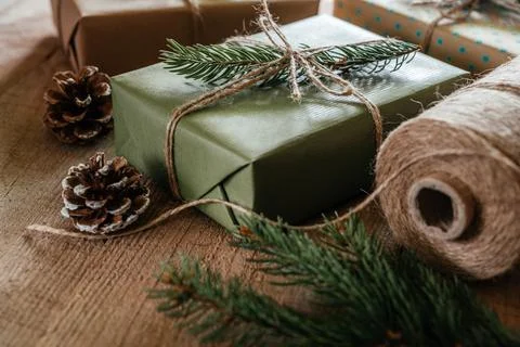 Christmas zero waste packaging gift boxes with pine cones, wooden eco decor and Stock Photos