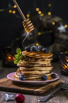 Christmass edition of stack of pancakes with fresh blueberries and a honey sp Stock Photos