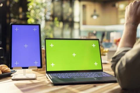 Chroma key and blue screen on laptop and tablet at the kitchen table Stock Photos