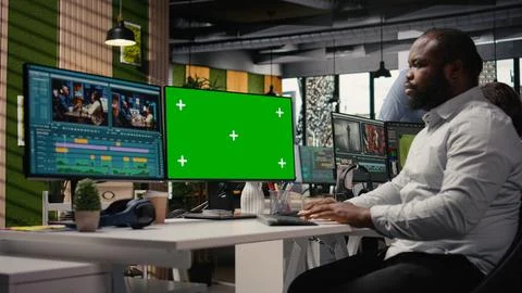 Chroma key with black man videographer refining video content Stock Photos