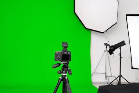 Chroma key compositing. Camera, green backdrop and equipment in studio Stock Photos