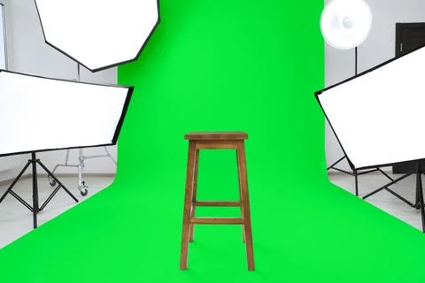 Chroma key compositing. Green backdrop, stool and equipment in studio Stock Photos