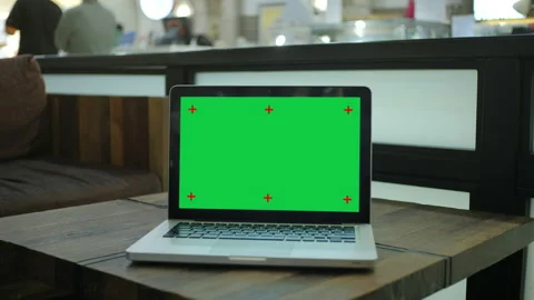 Chroma key green screen laptop computer set up for work on a cafe desk.	 Stock Footage 155269322