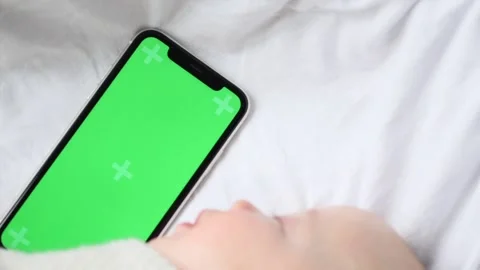 Chroma key green screen smartphone lying close to sleeping baby Stock Footage 152903072