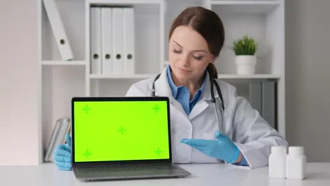 Chroma key green screen. The therapist, using a modern computer approach in her Stock Footage 263155372