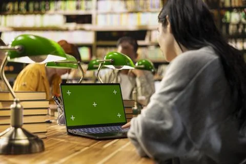 Chroma key isolated screen on laptop with student in over-the-shoulder shot Stock Photos