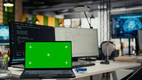 Chroma key laptop in empty startup office with artificial intelligence program 库存照片