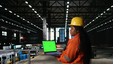 Chroma key on laptop screen with engineer in helmet examining metalwork Stock Footage 330140526