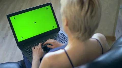 Chroma key on laptop screen. look over your shoulder. woman uses laptop at home Stock Footage 130403493