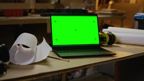 Chroma Key Laptop on Workbench with Carpentry Plans Stock Footage 340391495