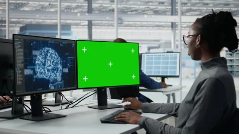 Chroma key PC used by microchip factory specialist reviewing production with AI Stock Footage 335880527
