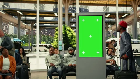 Chroma key screen in busy bus station with diverse people using bus connections Stock Footage 334721413