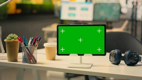 Chroma key screen at empty executive desk with tablet Stock Photos