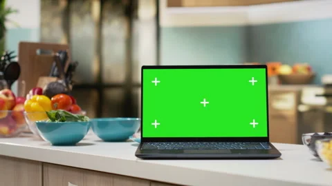 Chroma key screen laptop placed on empty wooden table in rustic kitchen space Stock Footage 326012022