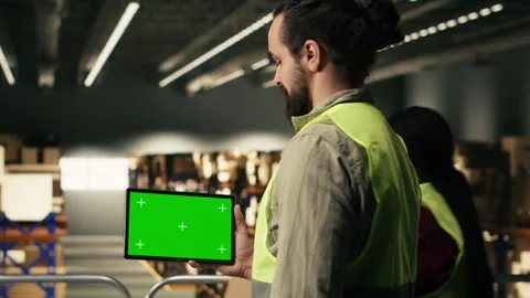 Chroma key screen on tablet near male staff working in industrial warehouse Stock Footage 330140061