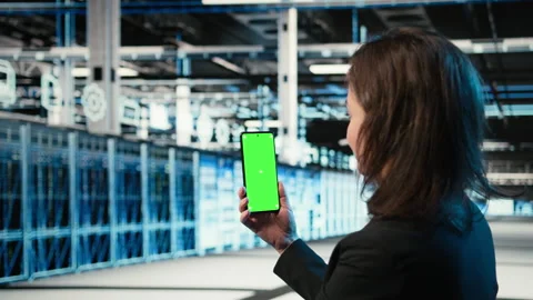 Chroma key smartphone used by data center admin to troubleshoot rigs issues Stock Footage 329323051
