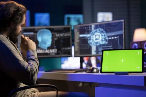 Chroma key tablet on desk next to self aware artificial intelligence Stock Photos