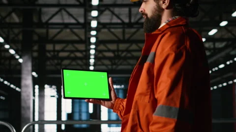 Chroma key tablet, engineer with hard hat, heavy industry, production line Stock Footage 330139662