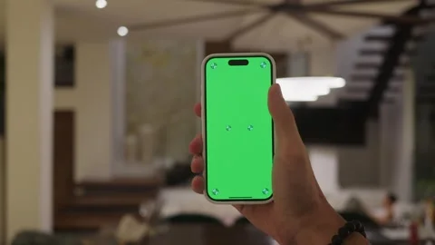 Chroma key technology in action hand holding smartphone with green screen chroma Stock Footage 312511596