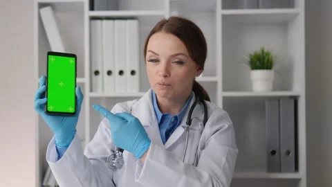 Chroma key template green screen smartphone phone held by doctor woman Stock Footage 267838246