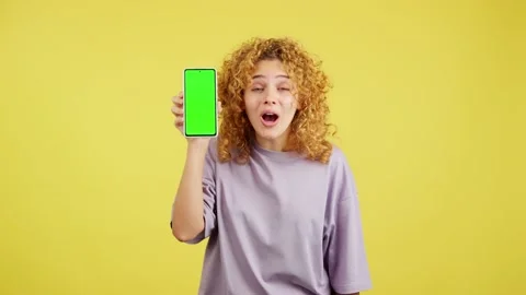 Chroma screen of the mobile held by a young woman Stock Footage 231605181