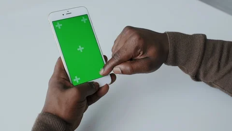 Chromakey or Greenscreen Touchpad on Handheld cellphone or Smartphone. African Stock Footage 120679197