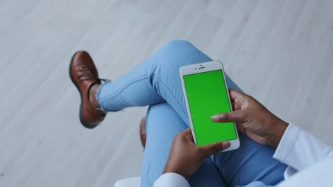 Chromakey or Greenscreen Touchpad on Handheld cellphone or Smartphone. African Stock Footage 121086905