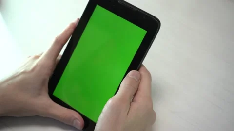 Chromakey, paste your video. mans hand hold tablet with green screen. Stock Footage 202045166