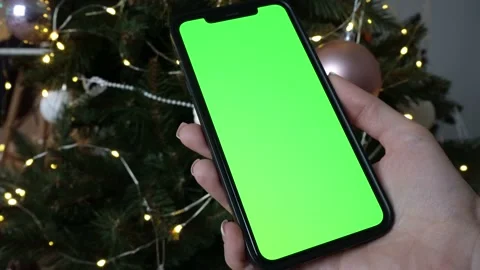 Chromakey phone on the background of the Christmas tree Stock Footage 230417456