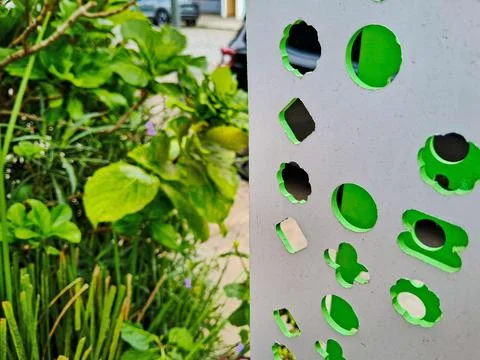 Chromatic combination between a signage panel and a planter. Stock Photos
