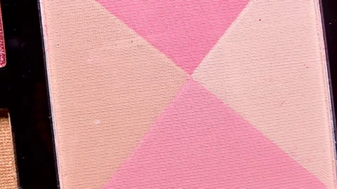 Chromatic Elegance: Macro Close-Up of Four Rotating Colored Eye Shadows Stock Footage 256160765