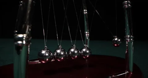 The chrome balls of a Newtons Cradle collidin. Newton Balls Moving Stock Footage 172243993