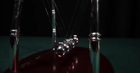 The chrome balls of a Newtons Cradle collidin. Newton Balls Moving Stock Footage 172351422