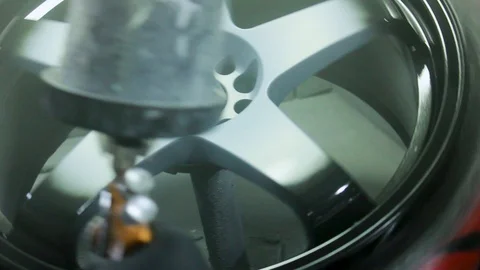 Chrome Black Alloy Wheels Being Spray Painted by a Mechanic at a Garage. Stock Footage 106678324