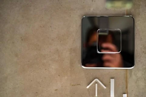 Chrome button to start tap water in public toilet Foto stock