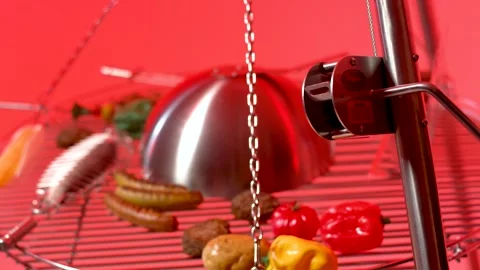Chrome Dome over Grill Grate with Sausages, Red Studio Background, Close Up Vídeo Stock 341512624