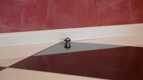 Chrome door stopper protecting the wall from damage by the door handle Stock Footage 297761818