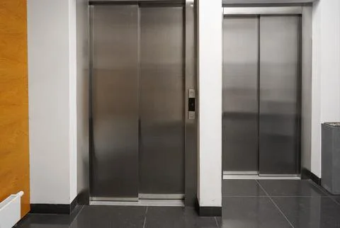 Chrome elevators in multi apartment modern house. elevator breakdown. Freig.. Stock Photos