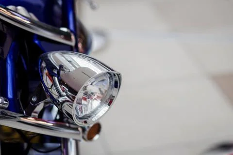 Chrome headlight of a motorcycle Stock Photos