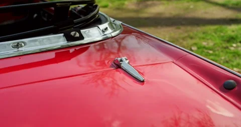 Chrome Hood Latch on Red Bonnet, Classic Sports Car, Paint Reflection Close Up Vídeo Stock 340648870