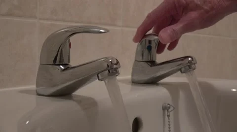 Chrome Hot and cold taps or faucet being turned on with sound of running water Stock Footage 67828055