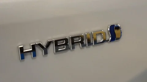 Chrome hybrid amblem on back of white car Stock Footage 88960487