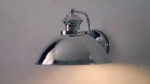 Chrome lamp in old-fashioned style on the wall, illuminates space with led lamps Stock Footage 297787423