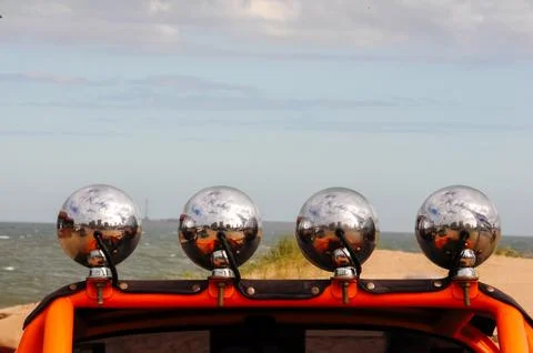 Chrome lights reflect seaside view on vintage car in Punta del Este, Uruguay Foto stock