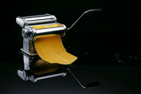 Chrome paste machine on a dark background with reflection Stock Photos