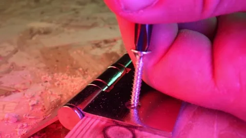 Chrome-plated shiny self-cutting screw close-up. Demonstration of the work on Stock Footage 160112157